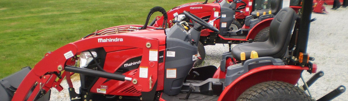 Mahindra® tractor parked outside in a lot with other tractors